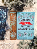 Load image into Gallery viewer, Woodgrain Thin Vertical Sign with light blue text that reads "Holiday Romance" surrounded by blue snowflakes and a bookstack. © FireDrake Aristry 2024