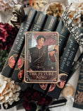 Load image into Gallery viewer, A decorative shelf sign featuring the 'The Future King' tarot card from the Blood and Ash series, with a book stack, crown, and decorative elements in the background.