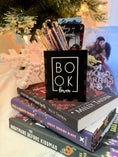 Load image into Gallery viewer, Black box with "Book Lover" printed on them. Bookstack and Christmas tree in the background.