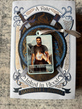 Load image into Gallery viewer, Tarot Card ornament titled "The Forehand" with silver ribbon and book underneath.