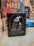 Load image into Gallery viewer, black box with printed design with 'Cozy Reader' text and a ghost with books, against a book stack and Christmas tree background.
