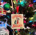 Load image into Gallery viewer, A rectangular wooden ornament featuring a Christmas tree of books next to a girl in a Santa hat tied up with Christmas lights surrounded by text that reads 'Good Girls Naughty List'. © FireDrake Artistry 2023