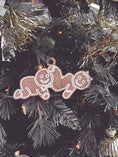 Load image into Gallery viewer, Ornament of a gingerbread man and woman in a smutty position. ©FireDrake Artistry 2024.