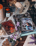 Load image into Gallery viewer, Witchy table with tarot cards, candle, and flowers