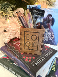 Load image into Gallery viewer, Wooden box with "Book Lover" printed on them. Bookstack and Christmas tree in the background.