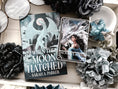 Load image into Gallery viewer, A 'Moonplume' Tarot Card featuring an illustration of a dragon ad a woman, placed next to the book 'When the Moon Hatched' by Sarah A. Parker, with a decorative background.