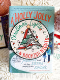 Load image into Gallery viewer, Round shelf sign with a white background. Image of books stacked into a Christmas tree surrounded by lights. The surrounding text reads "Christmas Lights" above in green, with "& Bookish Nights" below in red. © FireDrake Artistry 2025