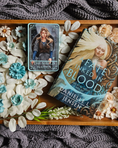 Load image into Gallery viewer, A decorative tarot card shelf sign featuring the card 'The Shield Maiden' with artwork depicting a female figure on a wooden tray with flowers, a blanket, and a book titles "A Fate Inked in Blood"