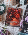 Load image into Gallery viewer, Tarot card with a dragon and person design on a mystical table setting.