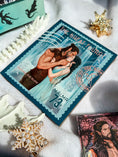 Load image into Gallery viewer, Postcard with a couple embracing on a beach, surrounded by decorative items.
