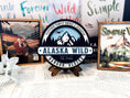 Load image into Gallery viewer, Officially Licensed K.A. Tucker "Alaska Wild Round Sign" created by FireDrake Artistry®