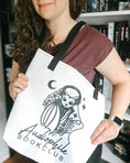 Load image into Gallery viewer, Audiophile Bookclub White Tote Bag from FireDrake Artistry™. Photo by @athousandbookishlives