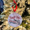Load image into Gallery viewer, Wooden ornament that reads "North Ploe Media Mail" featuring dragons and a stamp that says "Santa Dragon Approved." © FireDrake Artistry 2023