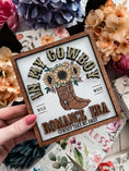 Load image into Gallery viewer, Sign with "In MY Cowboy Romance Era" and cowboy boots with flowers printed on it.Sign is held in a hand. Books and flowers in the background.