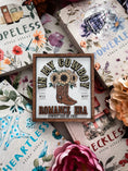 Load image into Gallery viewer, Sign with "In MY Cowboy Romance Era" and cowboy boots with flowers printed on it. Books and flowers in the background.