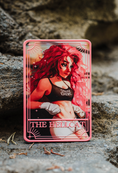 Load image into Gallery viewer, A pink tarot card labeled "The Hellcat" on a stone step