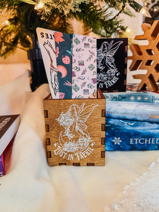Wooden box with printed fairy design and 'Lost in Faerie' text, against a Christmas tree background.