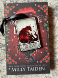 Load image into Gallery viewer, Tarot Card ornament titled "The Book Dragon" with black ribbon and book underneath.
