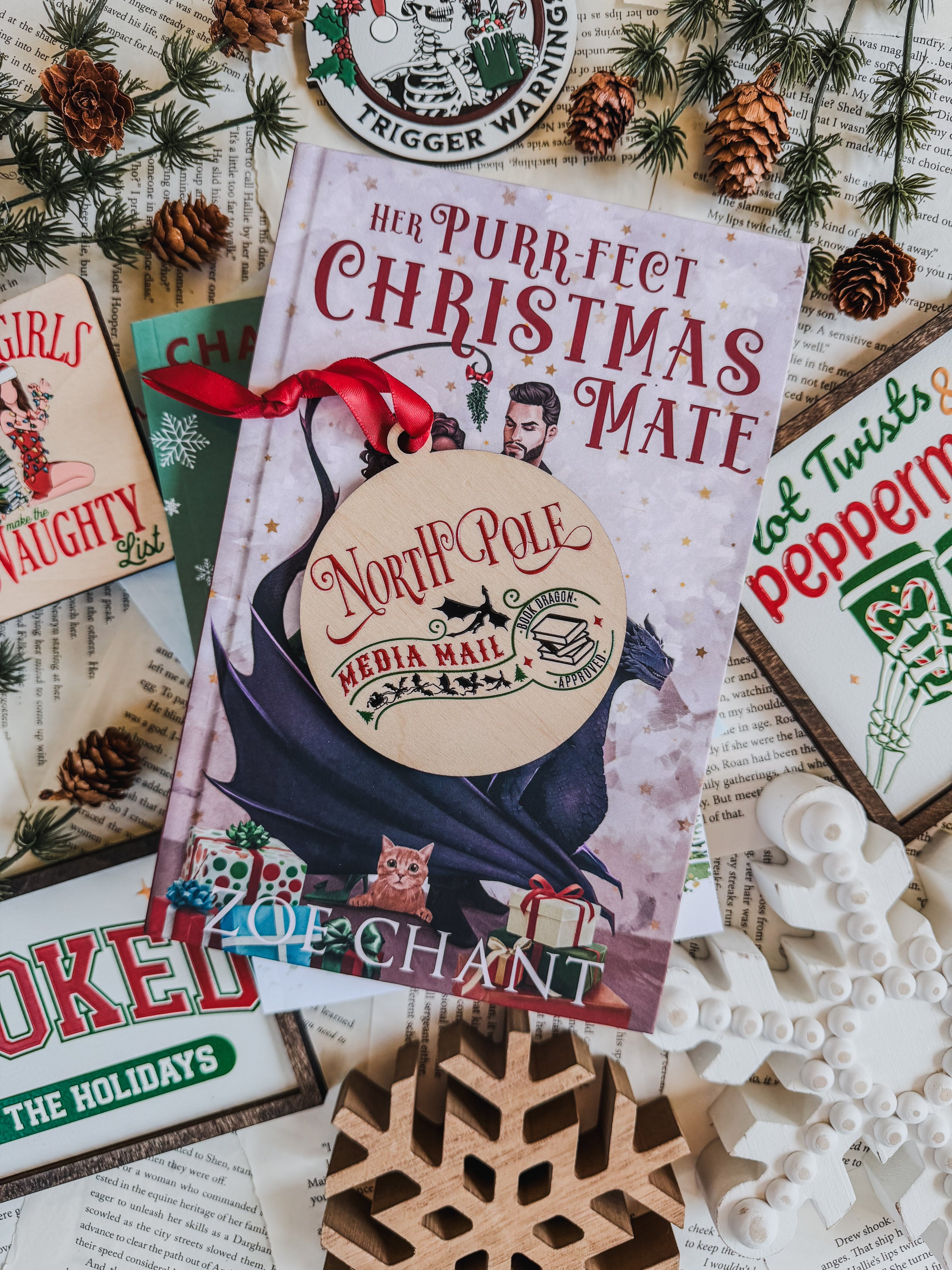 Wooden ornament that reads "North Pole Media Mail" featuring dragons and a stamp that says "Santa Dragon Approved." © FireDrake Artistry 2023 