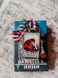 Load image into Gallery viewer, Stack of tarot card ornaments on top of a book with "The Book Dragon" on top. 
