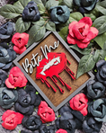 Load image into Gallery viewer, Bite Me Shelf Sign - FireDrake Artistry® wooden sign with natural background, dark grey frame, white "Bite Me" wording and red vampire lips. 
