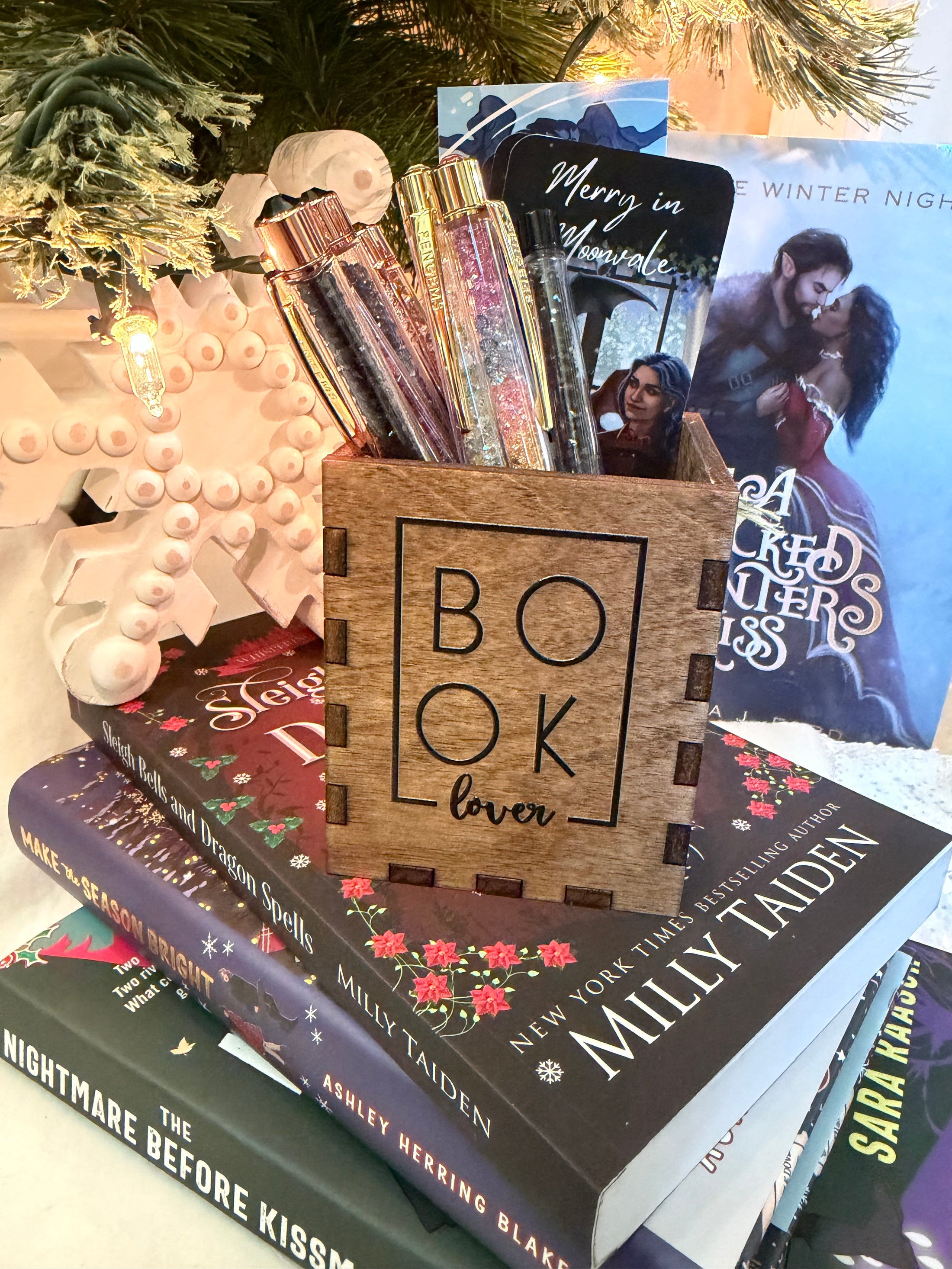 Wooden box with "Book Lover" printed on them. Bookstack and Christmas tree in the background. 