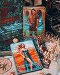 Load image into Gallery viewer, Two tarot cards titled 'The King' and 'The Assassin' on a surface with decorative items.
