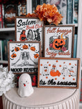 Load image into Gallery viewer, Four Halloween themed shelf signs featuring pumpkins, skeletons, and women in costumes. 

