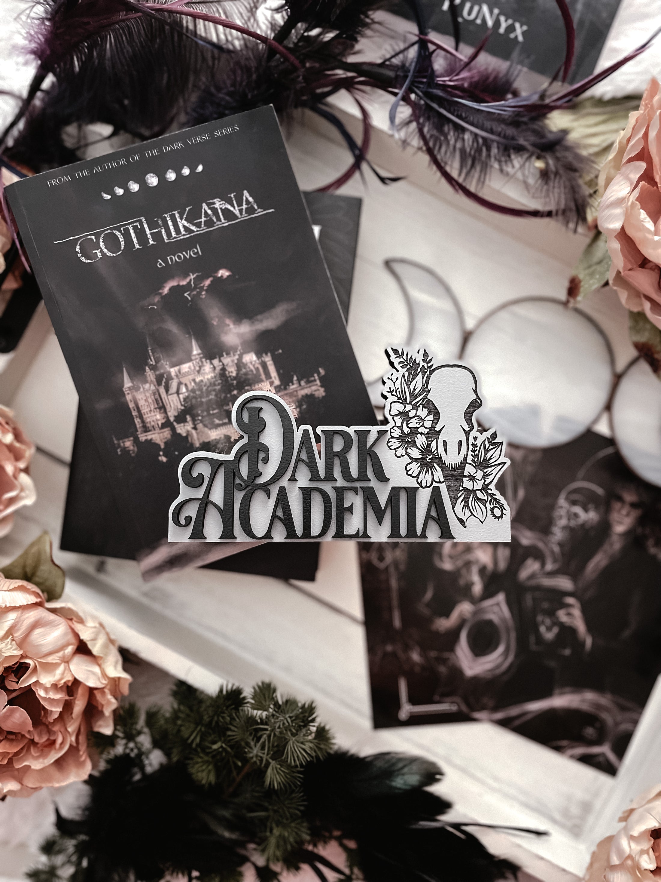 Dark Academia Sign. Grey wooden block sign with 3D text that reads "DARK ACADEMIA" beside a skull and flowers. 