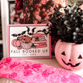 Load image into Gallery viewer, Fall Booked Up Sign - Pink Version- ©️ Fire Drake Artistry 2025. Wooden sign with white background and pink frame, UV printed design with a cluster of pumpkins beside a stack of pink books and bats flying around. 
