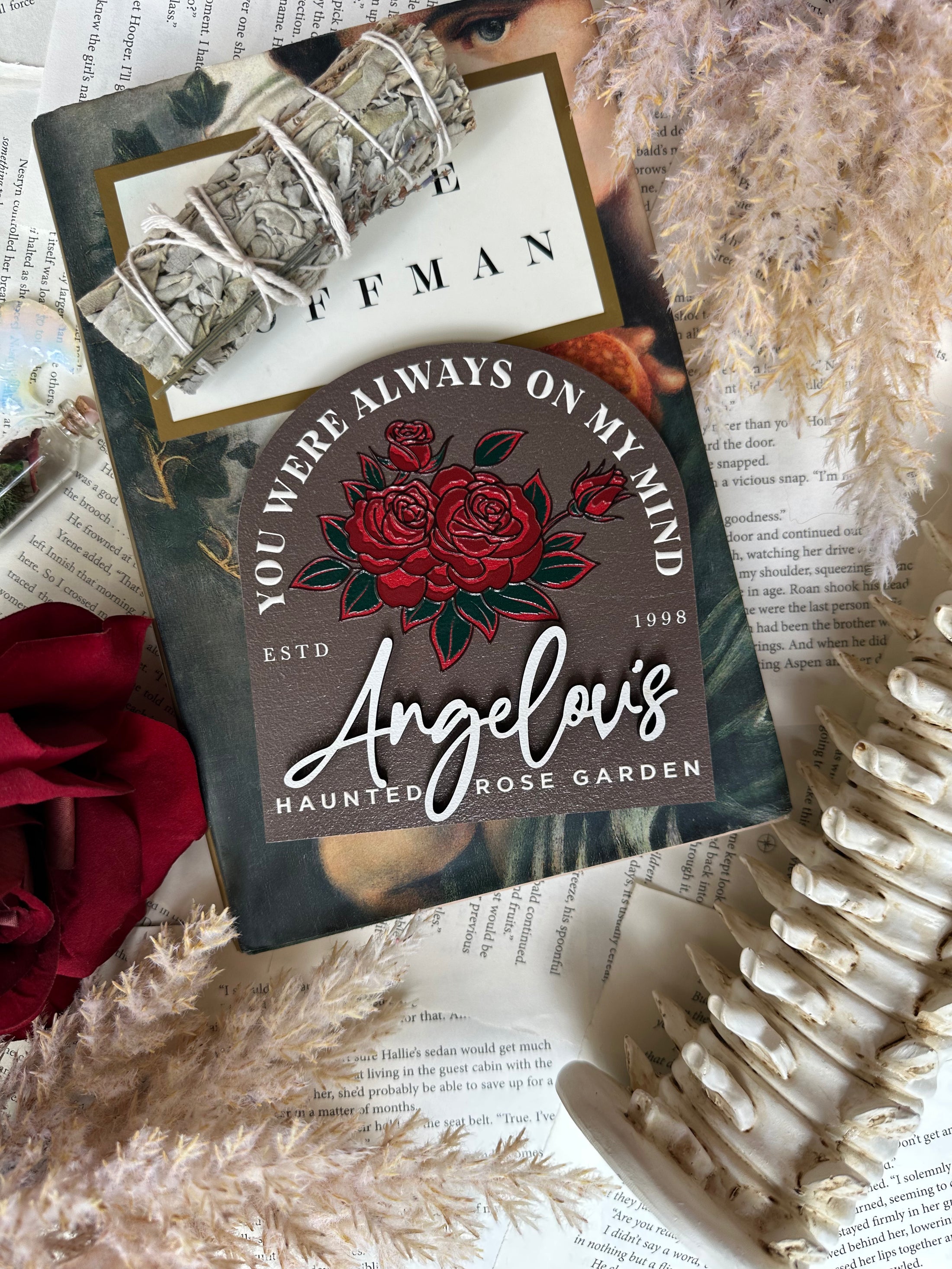 Book with 'You Were Always on My Mind' design and roses on a textured surface.