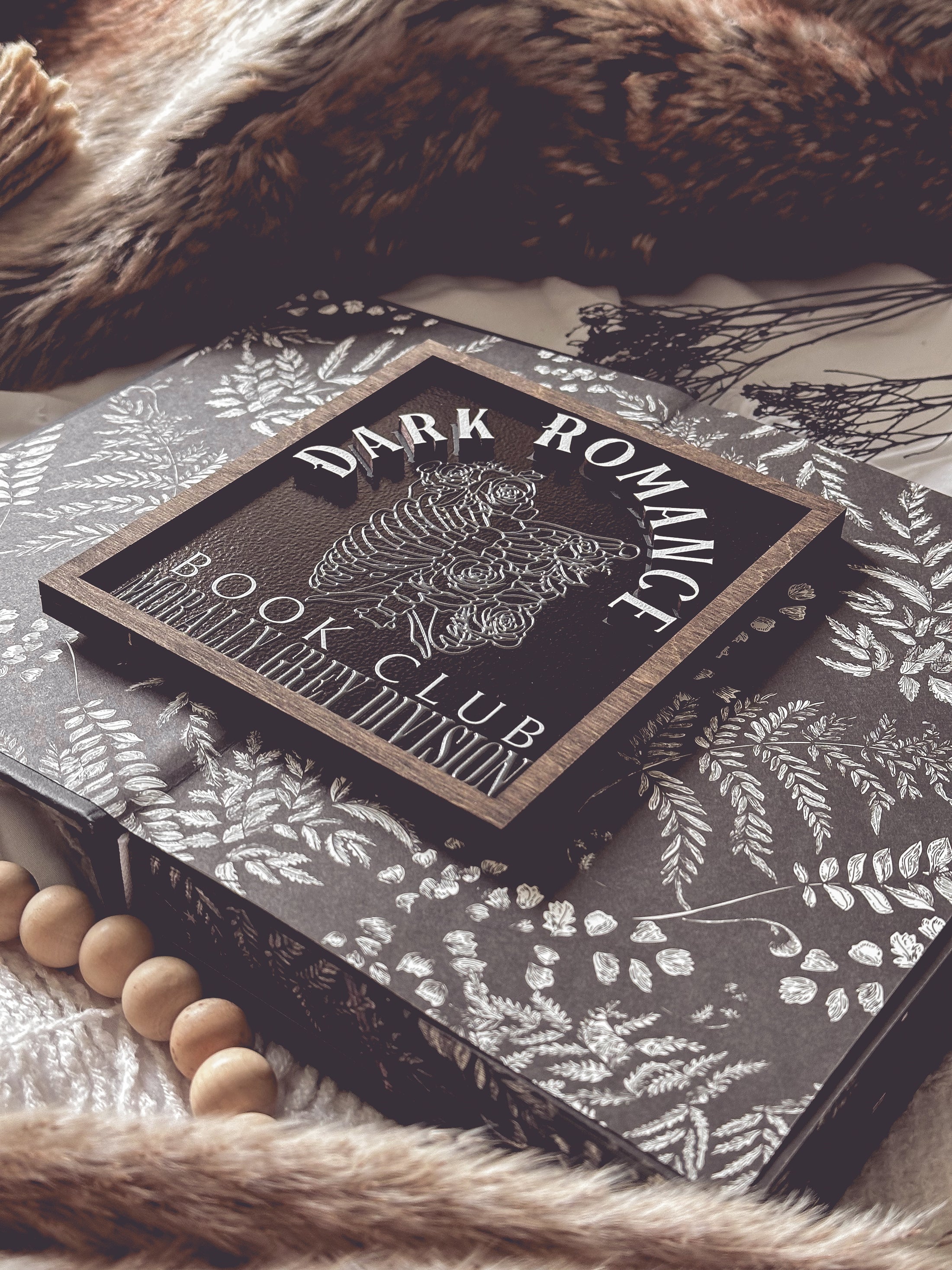 Dark Romance Book Club Sign . A decorative wooden book club sign with a dark brown border and black background. UV printed design that reads "DARK ROMANCE" at the top, and "Book Club Morally Grey Division" on the bottom. 2025 FireDrake Artistry®