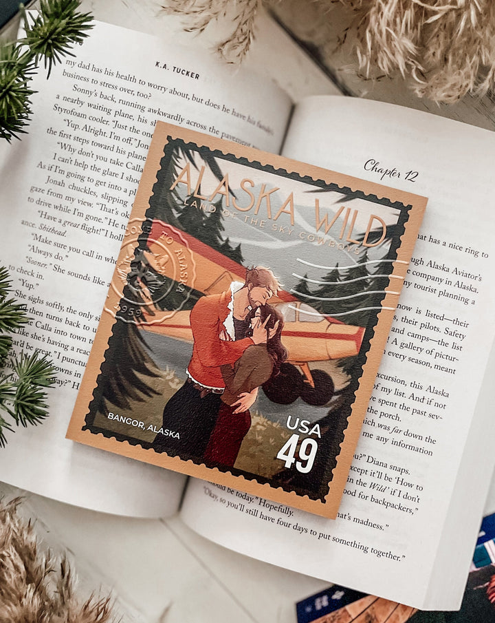 A postage stamp featuring artwork of a romantic scene on top of an open book and decorative flowers in the background.